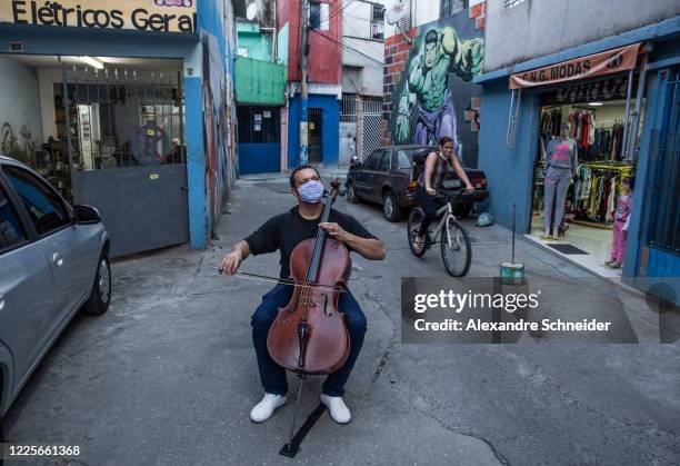 Marcos Mota cellist, plays in the streets of Heliopolis amidst the coronavirus pandemic on July 7, 2020 in Sao Paulo, Brazil. Marcos entered the...