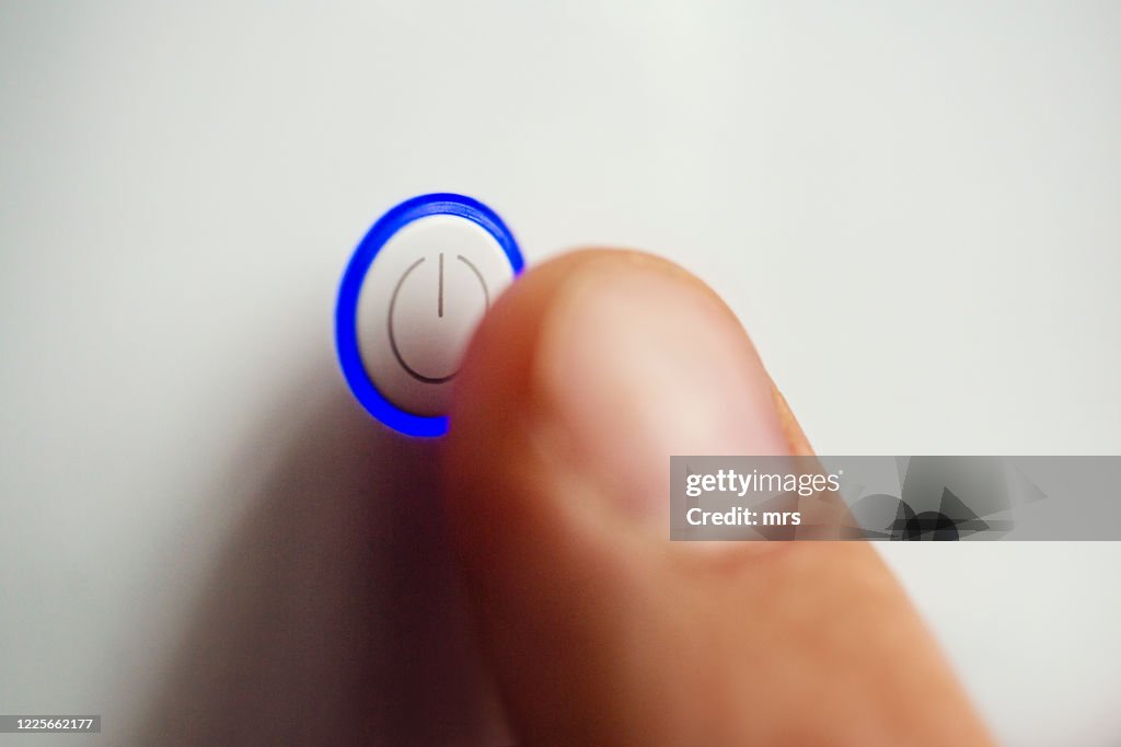 Hand pressing power button