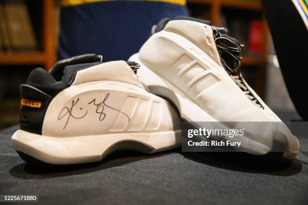 Pair of Kobe Bryant signed and game worn shoes are displayed at a press preview for sports legends featuring Kobe Bryant, FIFA and Olympic Medals at...