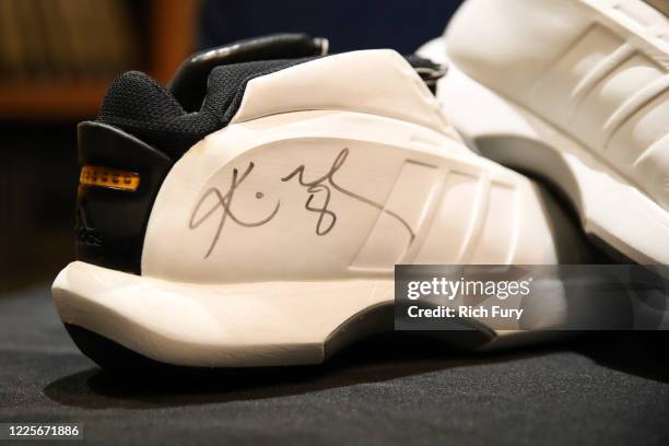 Pair of Kobe Bryant signed and game worn shoes are displayed at a press preview for sports legends featuring Kobe Bryant, FIFA and Olympic Medals at...