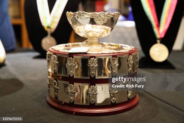 John McEnroe 1984 Davis Cup runner-up trophy is displayed at a press preview for sports legends featuring Kobe Bryant, FIFA and Olympic Medals at...