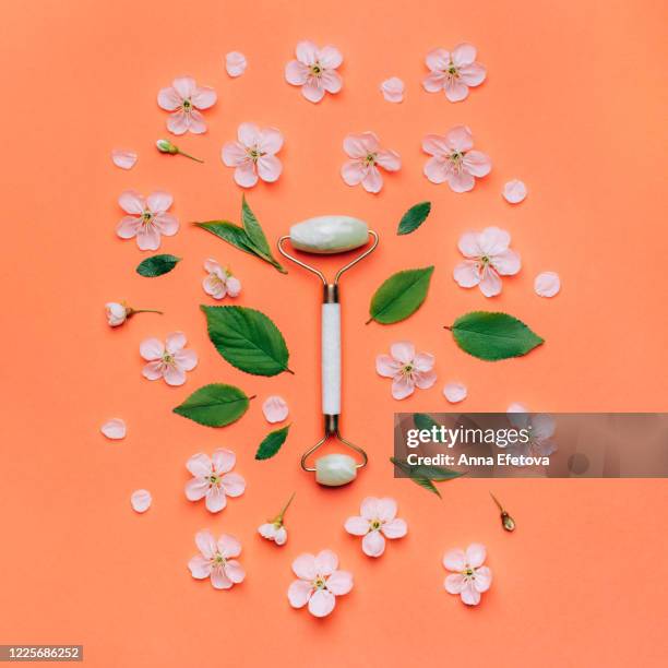 jade roller with flowers - massager stock pictures, royalty-free photos & images