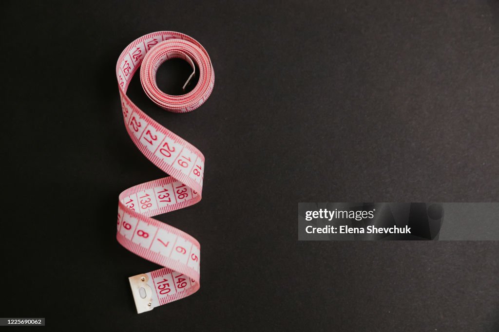 Tape measure isolated on black background