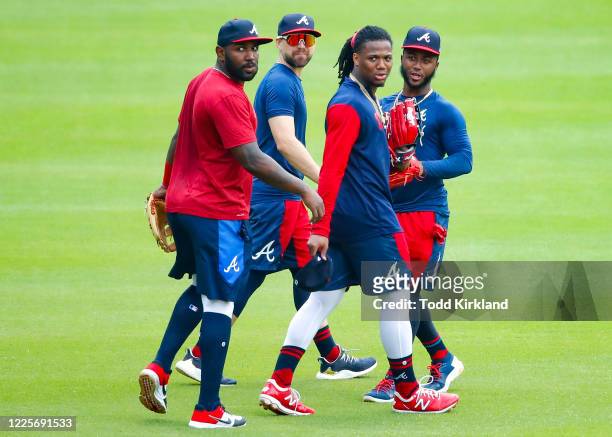 Marcell Ozuna, Ender Inciarte, Ronald Acuna Jr. #13 and Ozzie Albies of the Atlanta Braves head to the outfield during the summer workouts at Truist...