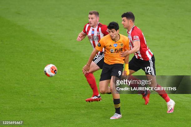 Wolverhampton Wanderers' Mexican striker Raul Jimenez vies with Sheffield United's English defender Jack O'Connell and Sheffield United's Irish...