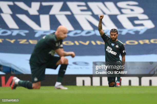Newcastle United's US defender DeAndre Yedlin takes a knee to show solidarity with the Black Lives Matter movement and against racism during the...