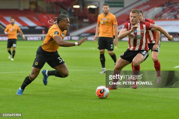 Wolverhampton Wanderers' Spanish midfielder Adama Traore vies with Sheffield United's English defender Jack O'Connell during the English Premier...