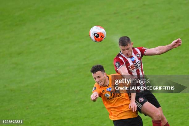 Wolverhampton Wanderers' Portuguese midfielder Diogo Jota vies with Sheffield United's English defender Jack O'Connell during the English Premier...