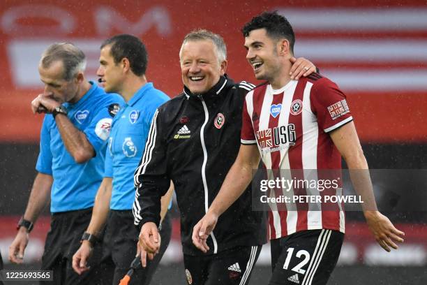 Sheffield United's Irish defender John Egan is congratulated by Sheffield United's English manager Chris Wilder after scoring a goal during the...