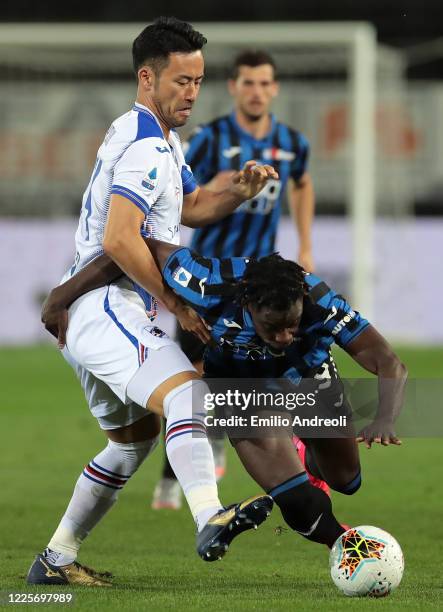 Duvan Zapata of Atalanta BC is challenged by Maya Yoshida of UC Sampdoria during the Serie A match between Atalanta BC and UC Sampdoria at Gewiss...