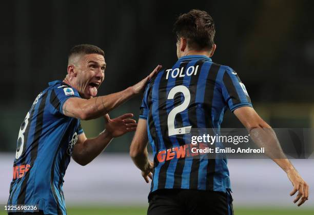 Rafael Toloi of Atalanta BC celebrates with his team-mate Robin Gosens after scoring the opening goal during the Serie A match between Atalanta BC...