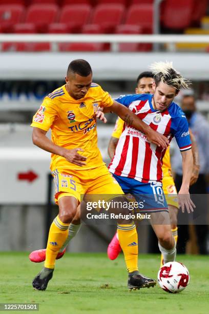 Jesús Angulo of Chivas fights for the ball with Rafael de Souza of Tigres during the match between Chivas and Tigres UANL as part of the friendly...