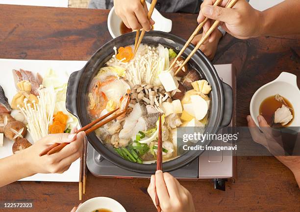 parents and children eating japanese nabe - japanese family ストックフォトと画像