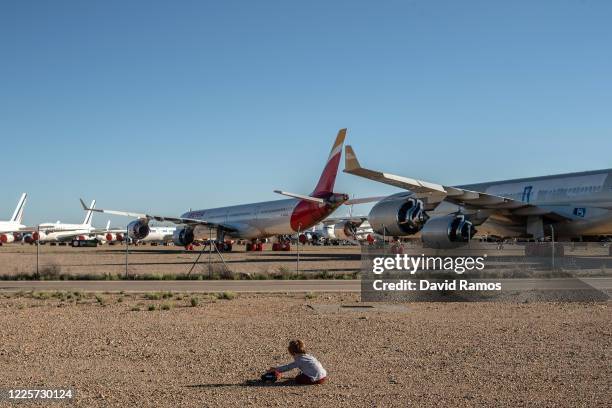 Leo plays with his toys outside the Teruel Airport on May 18, 2020 in Teruel, Spain. The airport, which is used for aircraft maintenance and storage,...