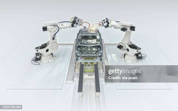 assembly line of robots welding car body - robotic car stock pictures, royalty-free photos & images