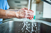 Nurse washing hands to avoid covid 19