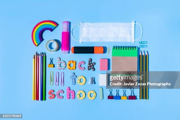 colorful magnetic letters forming the words "back to school" surrounded by stationery - spelling stock photos et images de collection