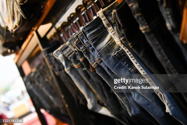 denim jeans on hanger - menswear stock pictures, royalty-free photos & images