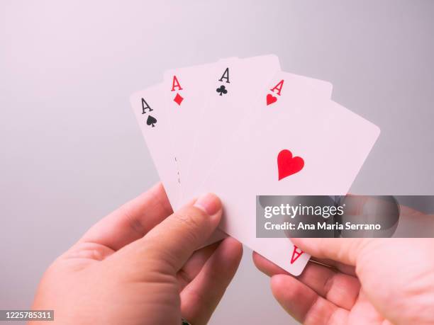 a person with playing poker with cards in his hand - diamonds playing card stock-fotos und bilder