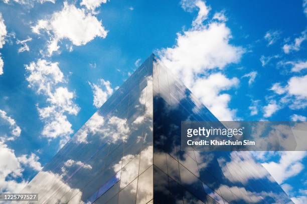 sky and cloud reflection on building - skyscraper stock pictures, royalty-free photos & images