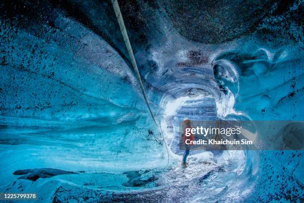 ice cave in iceland - caveman stock-fotos und bilder