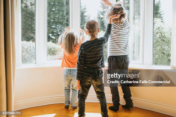 kids at a window - child waving stock pictures, royalty-free photos & images