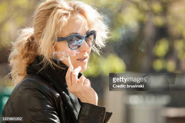 outdoors portrait of a 45 year old woman - smoking issues stock pictures, royalty-free photos & images