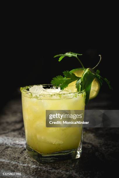 jalapeno lime margarita on black background - fancy bar stock pictures, royalty-free photos & images