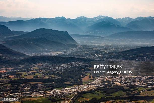 aerial view on the french city of chambery and its surroundings at dusk with mist between the alps mountains - chambéry stock pictures, royalty-free photos & images