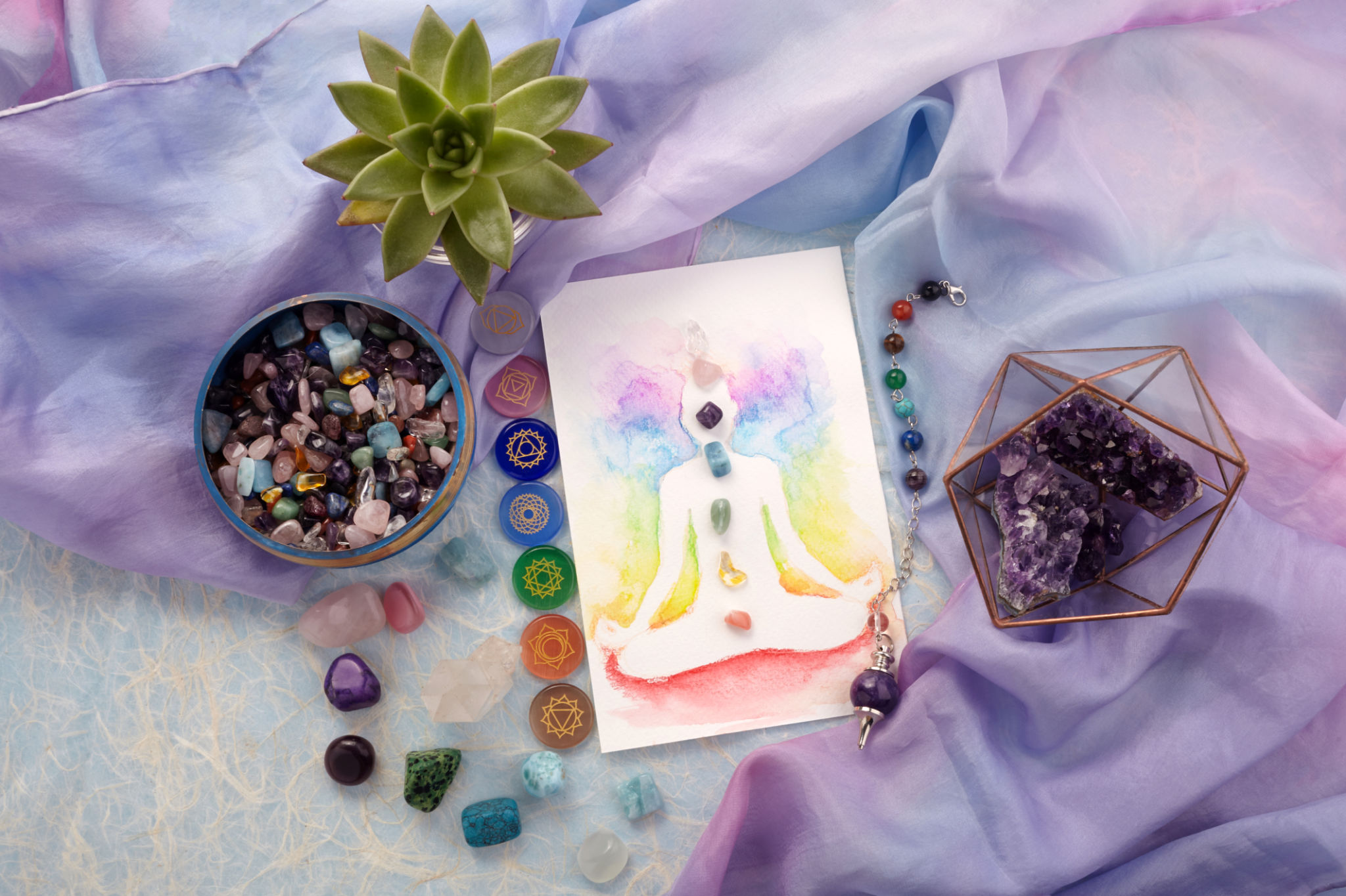 Natural crystals and pendulum on pastel silk background. Reiki background with card. Natural crystals and pendulum on pastel silk background. Reiki background with card.