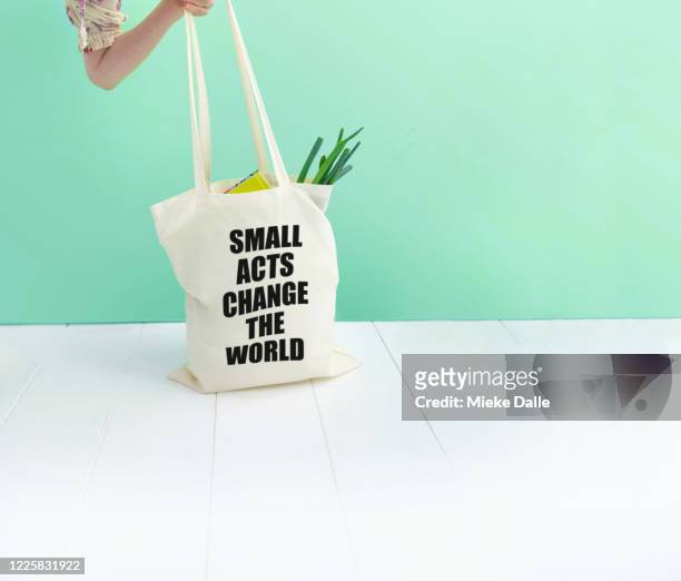 boodschappentas met boodschap 'small acts change the world" - boodschappentas imagens e fotografias de stock
