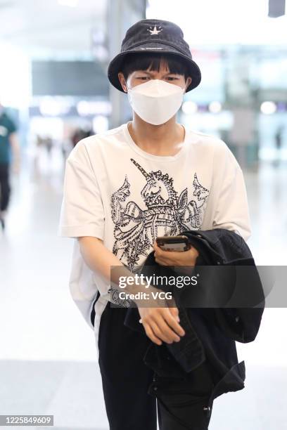Model He Sui wearing a face mask arrives at an airport on May 19
