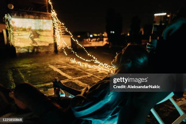 rooftop movie nights - rooftop party night stock pictures, royalty-free photos & images