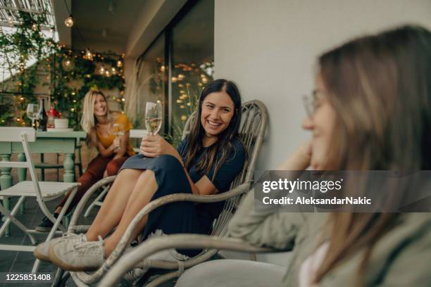 enjoying good wine on the open terrace - girlfriend stock pictures, royalty-free photos & images