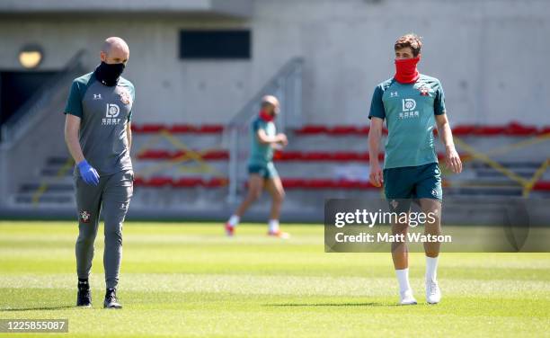 Jack Stephens talks to fitness coach Bill Styles as Southampton FC players return to training following Covid-19 restrictions being relaxed, at the...