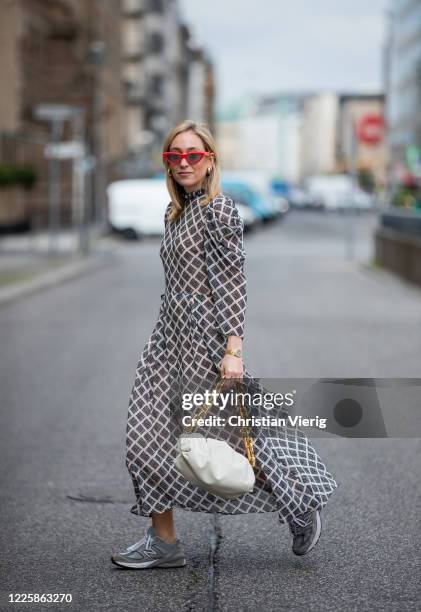 Sonia Lyson is seen wearing grey New Balance sneaker, grey checkered dress Hofmann Copenhagen, white bag Bottega Veneta, watch Patek Philippe...