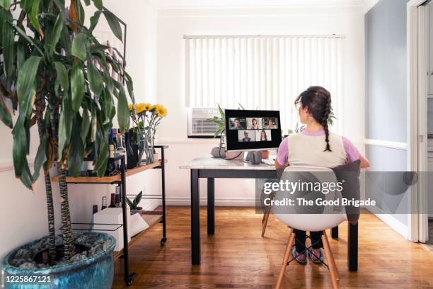 woman on video conference call with colleagues at home - zoom screen stock pictures, royalty-free photos & images