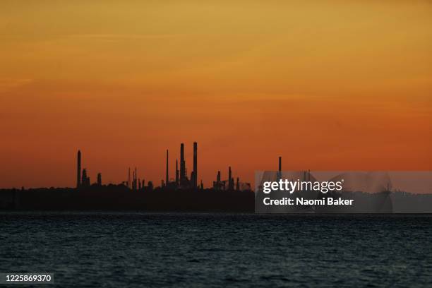 General view over The Solent water way towards Fawley Oil Refinery as the sun sets on May 19, 2020 in Lee-On-The-Solent, England. The British...