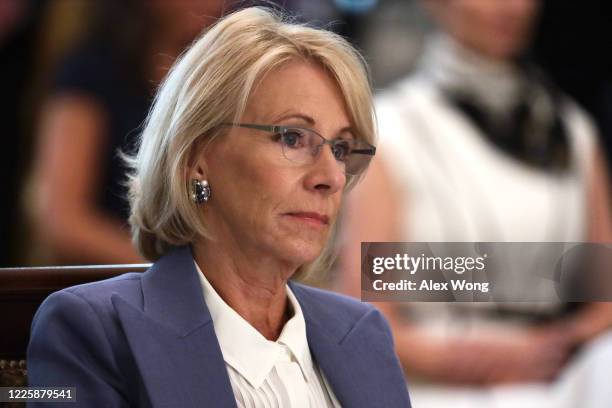 Secretary of Education Betsy DeVos listens during a cabinet meeting in the East Room of the White House on May 19, 2020 in Washington, DC. Earlier in...