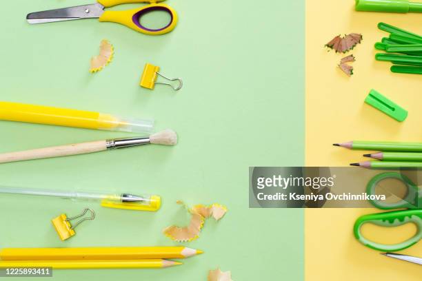 creative, fashionable, minimalistic, school or office workspace with yellow supplies on cyan background. flat lay. - desk of student alarm clock books and pencils foto e immagini stock