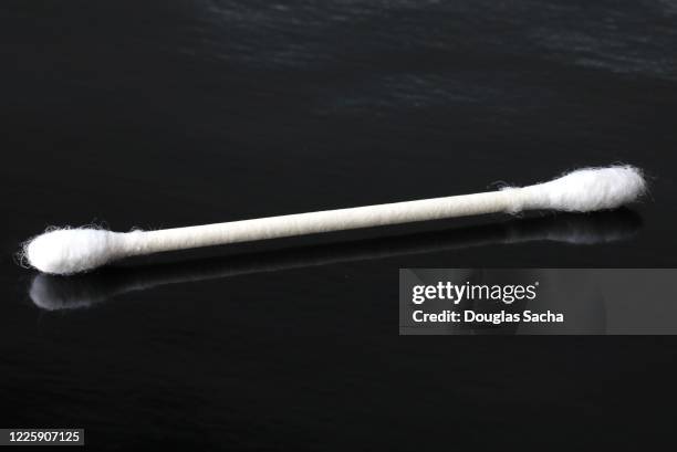 disposable single use cotton swab on a black background - 綿棒 ストックフォトと画像