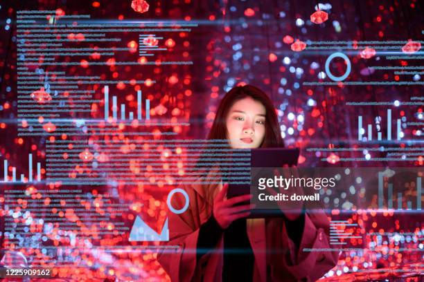 young woman uses digital tablet on virtual visual screen at night - big data stock-fotos und bilder