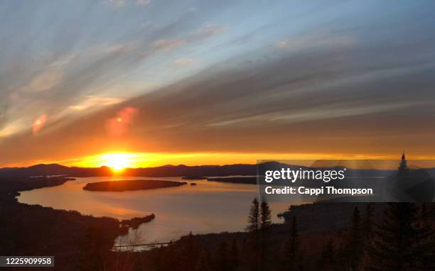 sunset view of lake mooselookmeguntic near rangeley, maine usa during springtime - mooselookmeguntic lake stock pictures, royalty-free photos & images