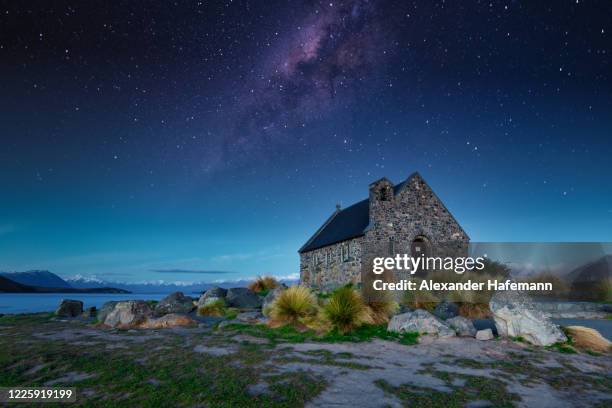 under the stars good shepherd's chapel night sky lake tekapo new zealand - lake tekapo ストックフォトと画像