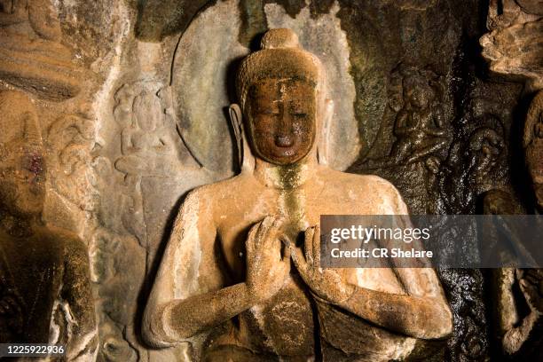 buddha statue inside of pandav leni the buddha caves at nashik, maharashtra, india. - nasik caves stock pictures, royalty-free photos & images