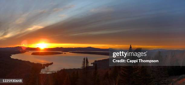 sunset over lake mooselookmeguntic near rangeley, maine usa during springtime - mooselookmeguntic lake stockfoto's en -beelden