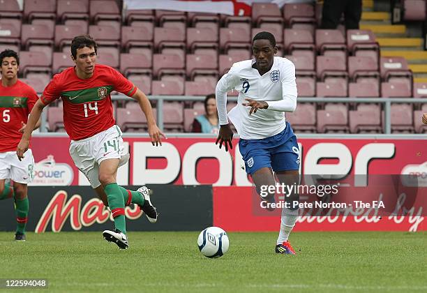 Devante Cole of England moves away with the ball from Alexandre Alfaiate of Portugal during The FA International U17 Tournement match between England...