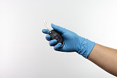 Hand with protective gloves holding a car key