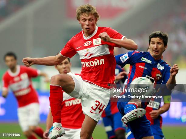 Evgeni Makeev of FC Spartak Moscow battles for the ball with Evgeni Aldonin of PFC CSKA Moscow during the Russian Football League Championship match...