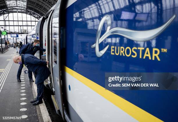 Passengers wearing protective face masks, get off an Eurostar train at Amsterdam Central Station, on July 9, 2020. After a stop due to the COVID-19...
